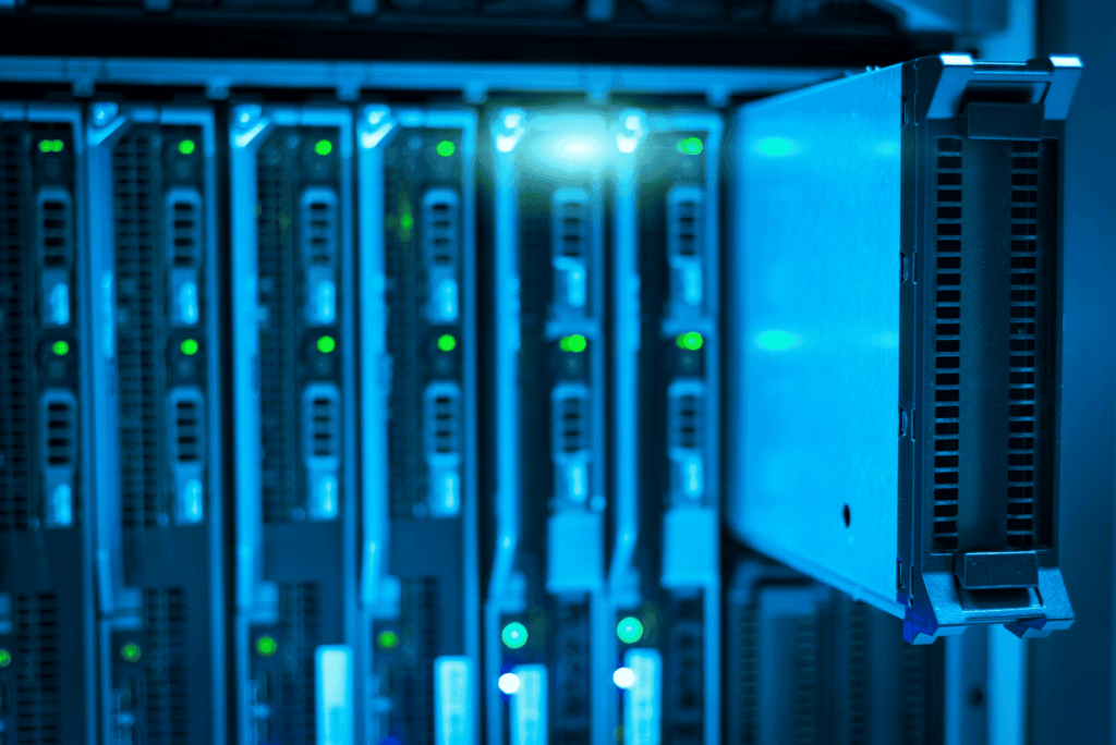 The 3 Types of Data Backups Every Small Business Needs High-tech data center server racks with green indicator lights in a modern IT infrastructure.