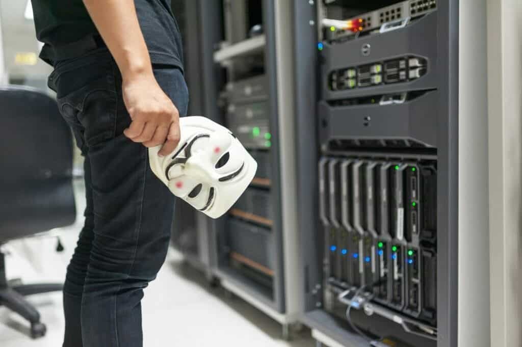 High-tech data server room with a technician holding a white mask.