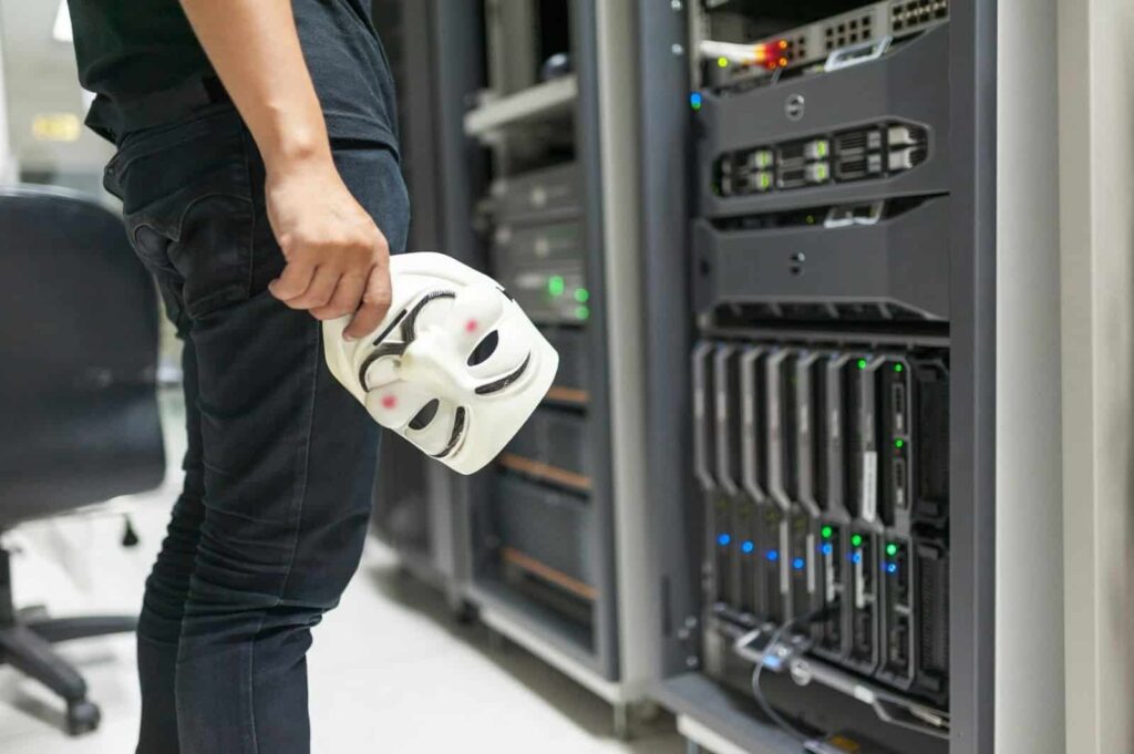 Is Your Business Network a Ticking Time Bomb? High-tech data server room with a technician holding a white mask.