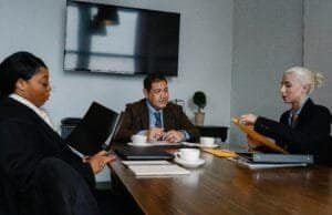 Diverse business professionals collaborating during a team meeting in a modern conference room.