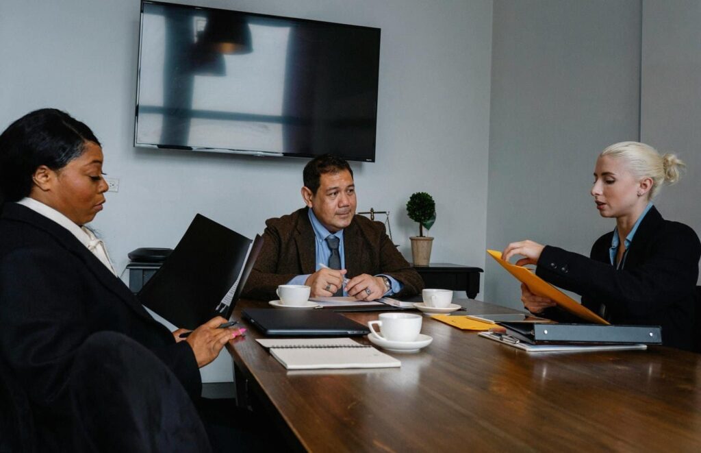 How Much Should a Small Business Budget for IT Support? Diverse business professionals collaborating during a team meeting in a modern conference room.