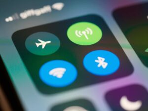 Blog Close-up of airplane mode, Wi-Fi, Bluetooth, and cellular signal icons on mobile device.