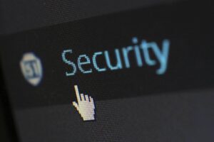 Blog Close-up digital screen showing "Security" text with a hand icon.