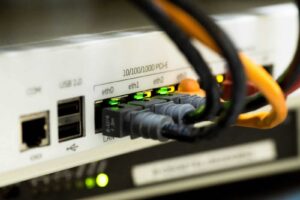 Blog Close-up of a network switch with Ethernet cables connected, highlighting high-speed data networking setup.
