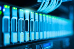 Blog High-tech server hardware with illuminated indicators for data center and IT management.